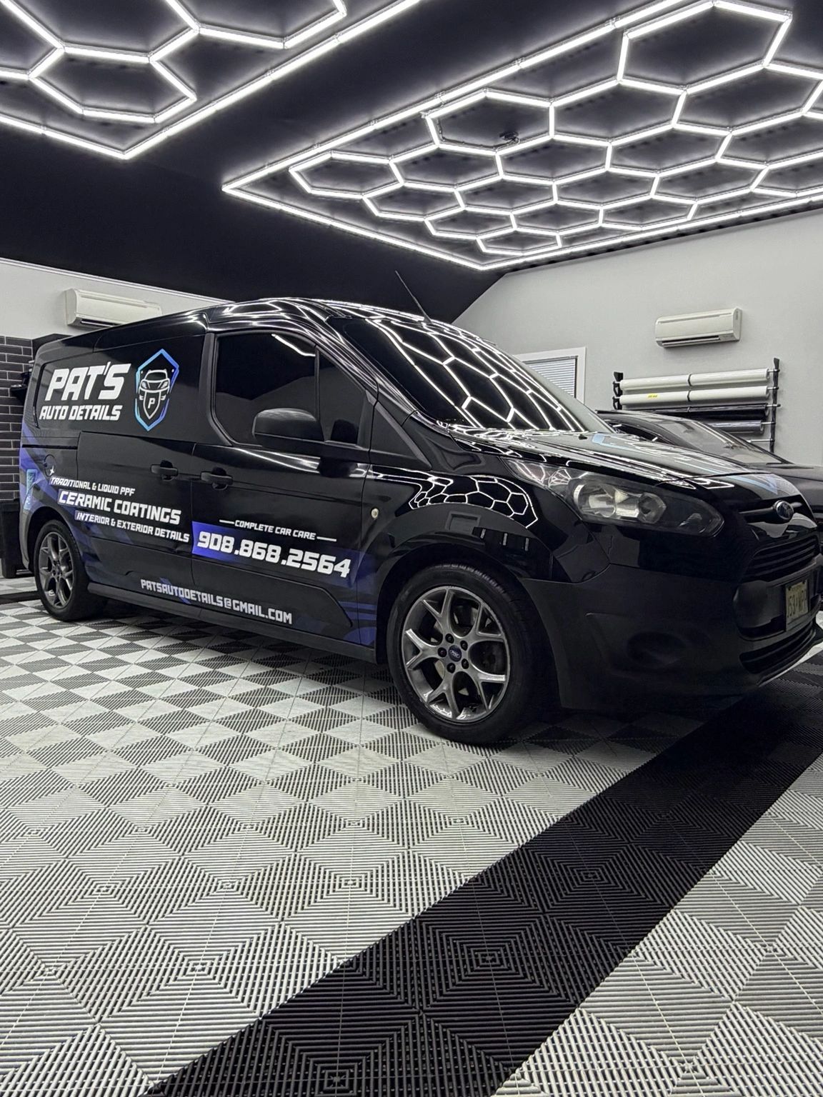 Pat's Auto Details branded van inside the Stewartsville detailing studio